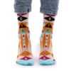Multicoloured geometric knit crew socks worn with cuffed light blue jeans.