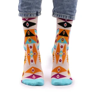 Multicoloured geometric knit crew socks worn with cuffed light blue jeans.