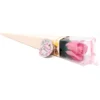 A pink soap rose in a cream cone gift box with a clear plastic cover.