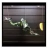 A green metallic marionette dragon puppet with curled tail suspended by strings against a dark background.