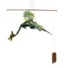 A handmade green dragon mobile hanging from a wooden dowel, appearing to fly midair.