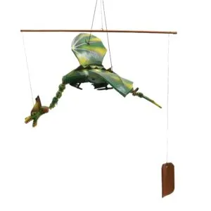 A handmade green dragon mobile hanging from a wooden dowel, appearing to fly midair.