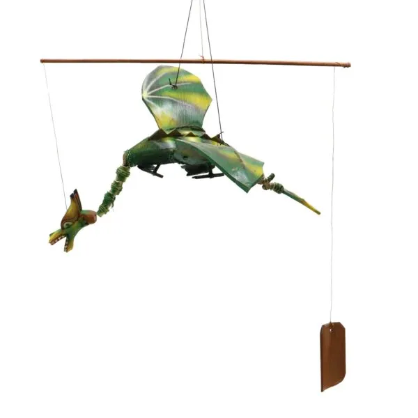 A handmade green dragon mobile hanging from a wooden dowel, appearing to fly midair.