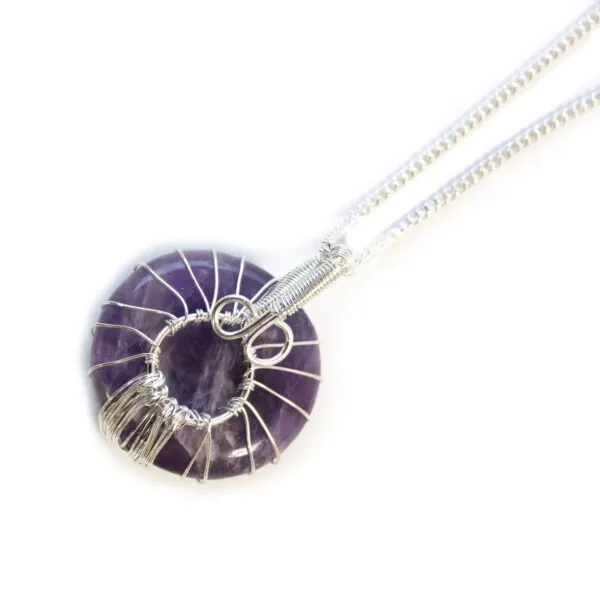 Silver-wire wrapped amethyst donut pendant necklace with intricate handmade design on a silver chain.