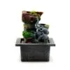 Elephant Resin Tabletop Fountain Grey - Natural Rock Waterfall A tabletop elephant waterfall fountain with rocky design and green plants on a black stone base.