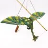 A handcrafted wooden dragon marionette with green and yellow wings suspended by control strings.