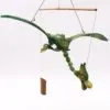 A handcrafted green bamboo dragon sculpture hanging from strings in a mobile display.