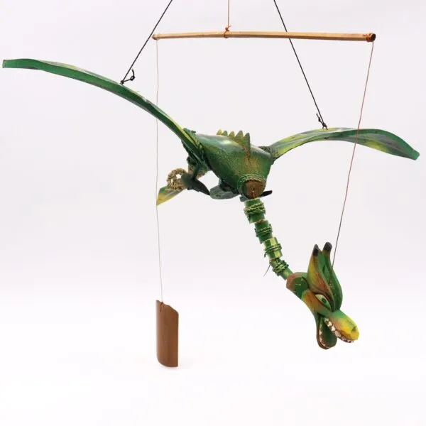 A handcrafted green bamboo dragon sculpture hanging from strings in a mobile display.