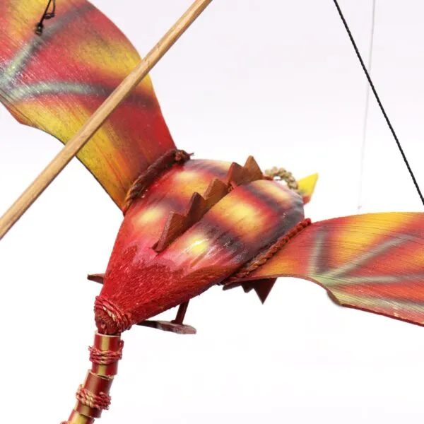 A handcrafted wooden bird mobile painted in red, yellow, and orange, suspended by black strings.
