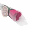 A pink rose-shaped soap flower wrapped in clear plastic with a floral “SOAP flower” label.