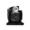 Modern black ribbed resin sculpture with clear crystal sphere symbolising balance and contemporary style.