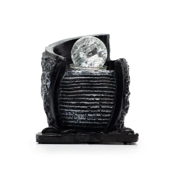 Modern black ribbed resin sculpture with clear crystal sphere symbolising balance and contemporary style.