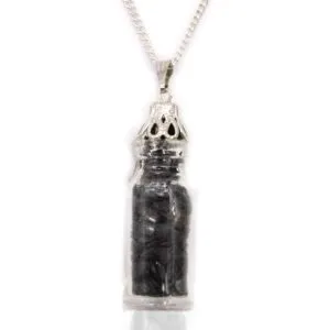 Silver glass vial necklace with glossy black stones and ornate cap, gothic jewellery charm.