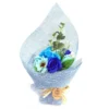 Elegant blue soap flower bouquet with roses and daisies wrapped in light blue mesh.