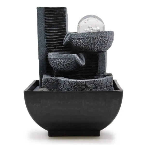 Modern charcoal stone tabletop fountain with tiered bowls and a clear glass sphere.