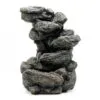 Stacked dark grey stone sculpture with rugged texture on a white background.