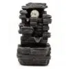 Dark grey layered stone tabletop fountain with cascading water tiers and glowing LED glass sphere.