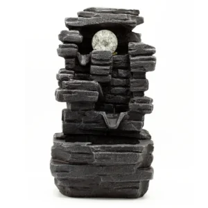 Dark grey layered stone tabletop fountain with cascading water tiers and glowing LED glass sphere.