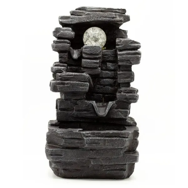Dark grey layered stone tabletop fountain with cascading water tiers and glowing LED glass sphere.