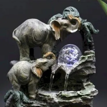 Elephant Water Fountain Resin Sculpture Grey - LED Globe Grey resin elephant water fountain with glowing LED crystal globe on textured rocky base.