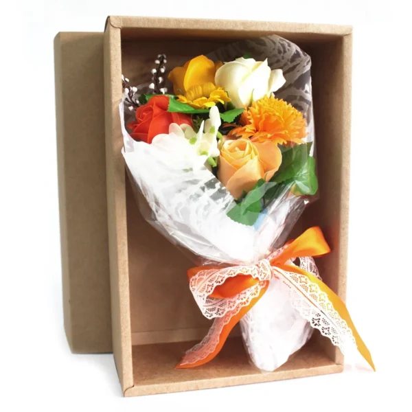 Elegant orange and yellow soap flower bouquet gift box with ribbon and tissue wrapping.