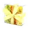 Clear acrylic gift box with pastel soap roses and a yellow satin ribbon bow.