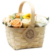 Pastel soap flower basket with peach roses and sunflower in a rustic woven wood design.