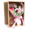 Elegant pink soap flower bouquet in lace wrap inside a kraft gift box.