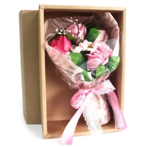 Elegant pink soap flower bouquet in lace wrap inside a kraft gift box.