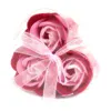 Four pink rose soap flowers in a clear heart box with pink striped ribbon.
