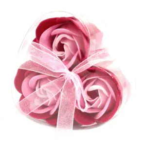 Four pink rose soap flowers in a clear heart box with pink striped ribbon.