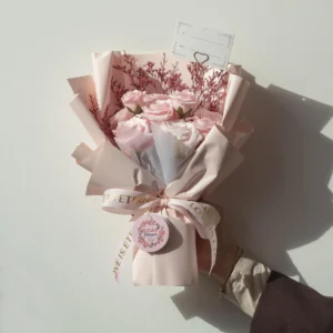 Elegant pink soap rose bouquet wrapped in pastel paper with “LOVE IS ETERNAL” ribbon gift.