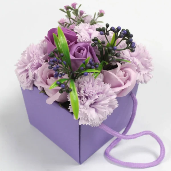 Purple Artificial Flower Bouquet Gift Box - Elegant Arrangement A purple artificial flower bouquet with roses and carnations in a square lavender gift box.