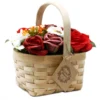 Rustic woven basket filled with red, mauve, and white soap flowers for elegant home décor.