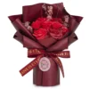 Red Soap Flower Bouquet Burgundy Wrap - Eternal Love Theme Red soap rose bouquet with pink baby’s breath, burgundy wrap, and “LOVE IS ETERNAL” ribbon.
