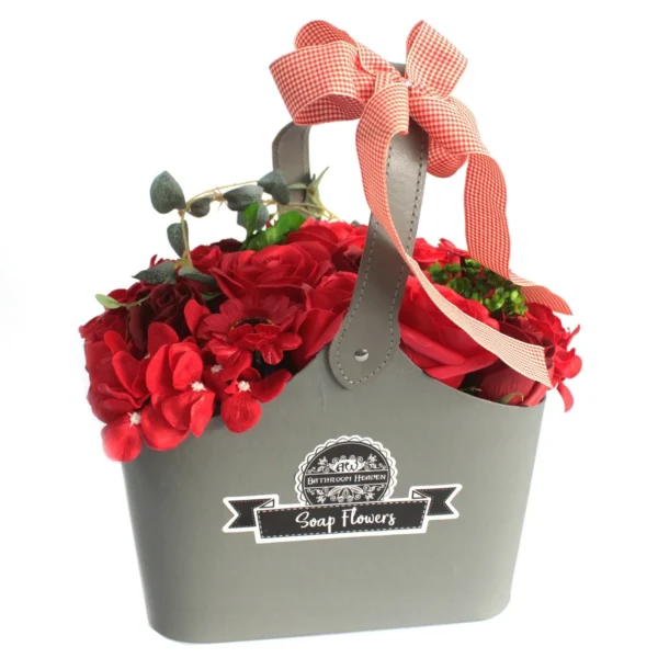 Grey container with red soap flowers and a red-and-white gingham bow gift arrangement.