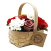 Handmade wicker basket with red, white, and pink soap roses and green leaves.