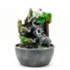 Grey resin elephant family fountain with crystal orb, palm tree, and playful monkey decoration.