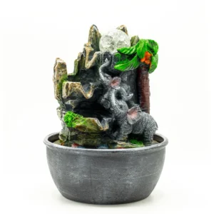 Grey resin elephant family fountain with crystal orb, palm tree, and playful monkey decoration.