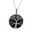 Handcrafted silver Tree of Life pendant on polished black gemstone with elegant silver chain.