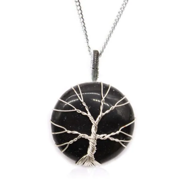 Handcrafted silver Tree of Life pendant on polished black gemstone with elegant silver chain.