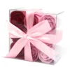 Elegant clear acrylic gift box with red and pink soap roses tied by a pale pink ribbon.