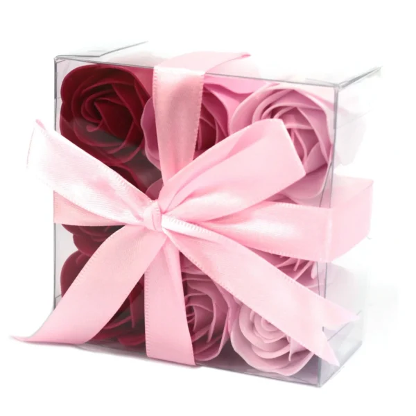 Elegant clear acrylic gift box with red and pink soap roses tied by a pale pink ribbon.