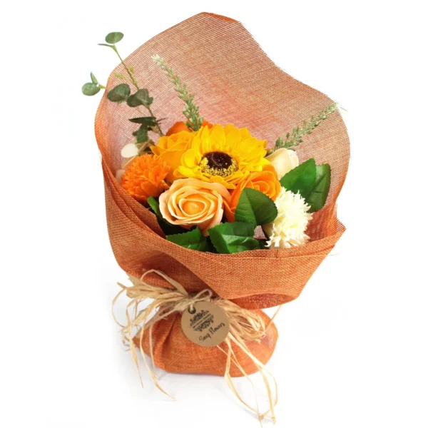 Sunflower and rose soap flower bouquet wrapped in orange mesh with raffia bow and brown tag.