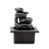 Small grey tabletop rock water fountain with cascading stones and tranquil decorative design.
