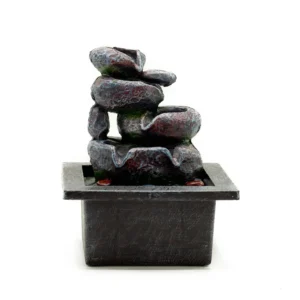 Small grey tabletop rock water fountain with cascading stones and tranquil decorative design.