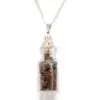 Silver necklace with glass bottle pendant holding polished brown and golden tiger’s eye gemstones.