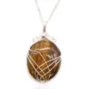 Handcrafted silver wire-wrapped tiger’s eye pendant with golden-brown shimmer on a delicate silver chain.