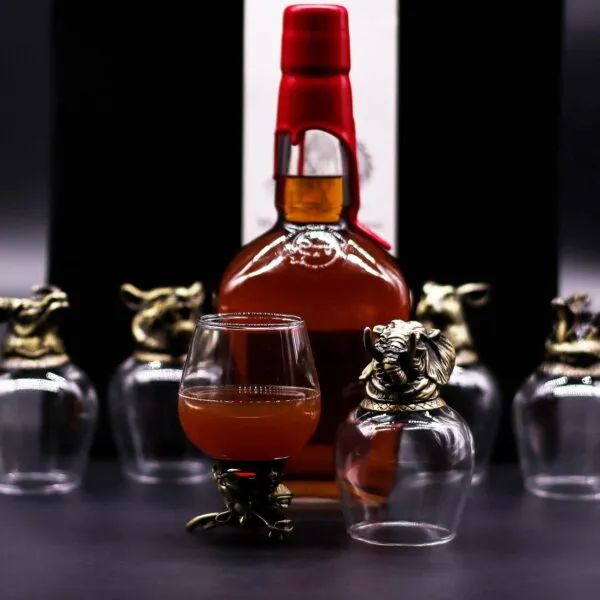 Gift Set of 6 Glasses (100ml). Amber whiskey bottle with gold animal-head shot glasses on a dark elegant background.