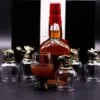 Whiskey Glass Set Metal Animal Base - Amber Collectors Edition Luxury whiskey set with animal‑sculpted metal base glasses and amber bottle on dark backdrop.